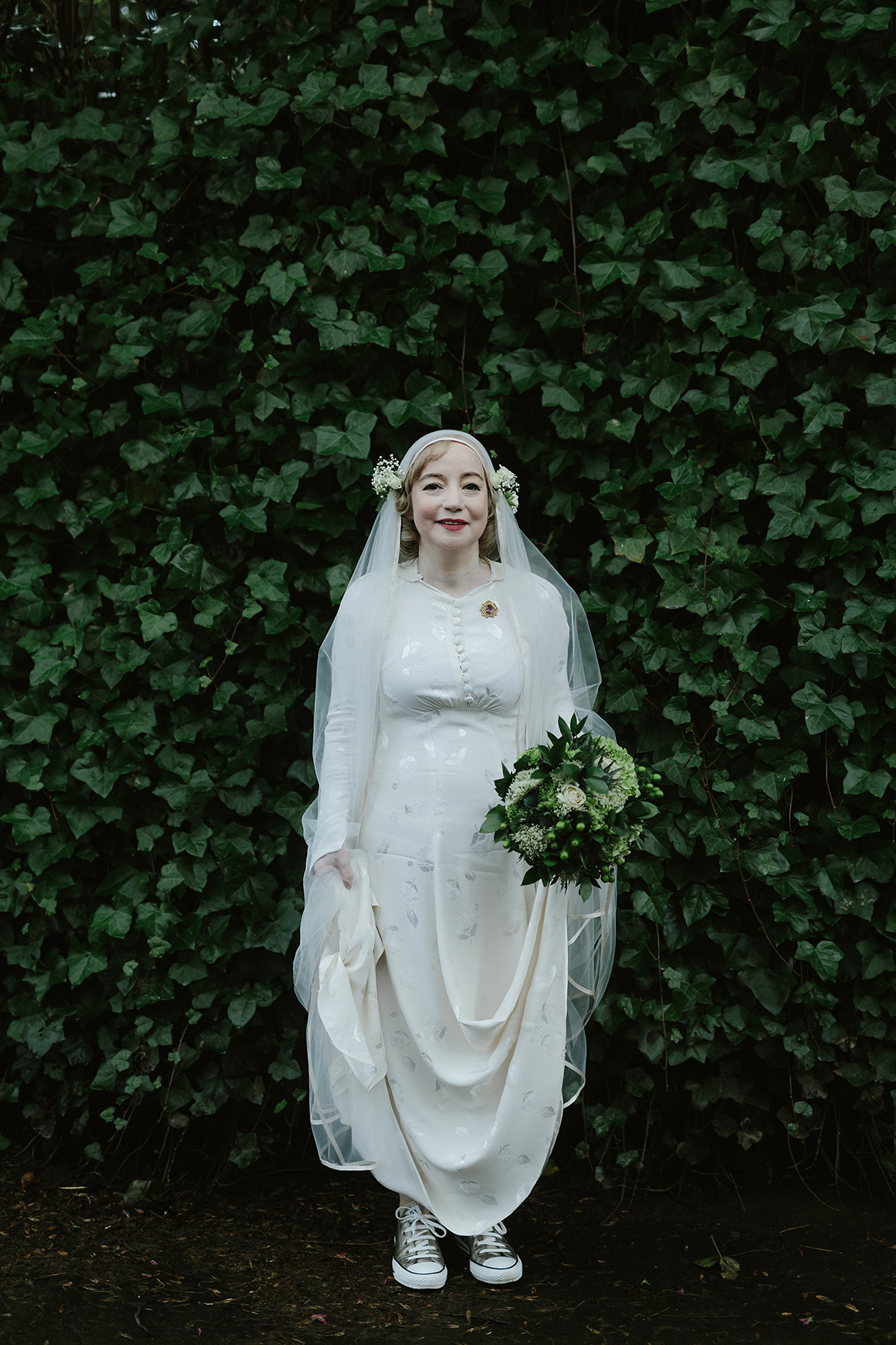 Berenice wore a 1930's vintage wedding dress for her intimate wedding held at home. The couple's ceremony involved a traditional Celtic handfasting. Photography by Rooftop Mosaic.