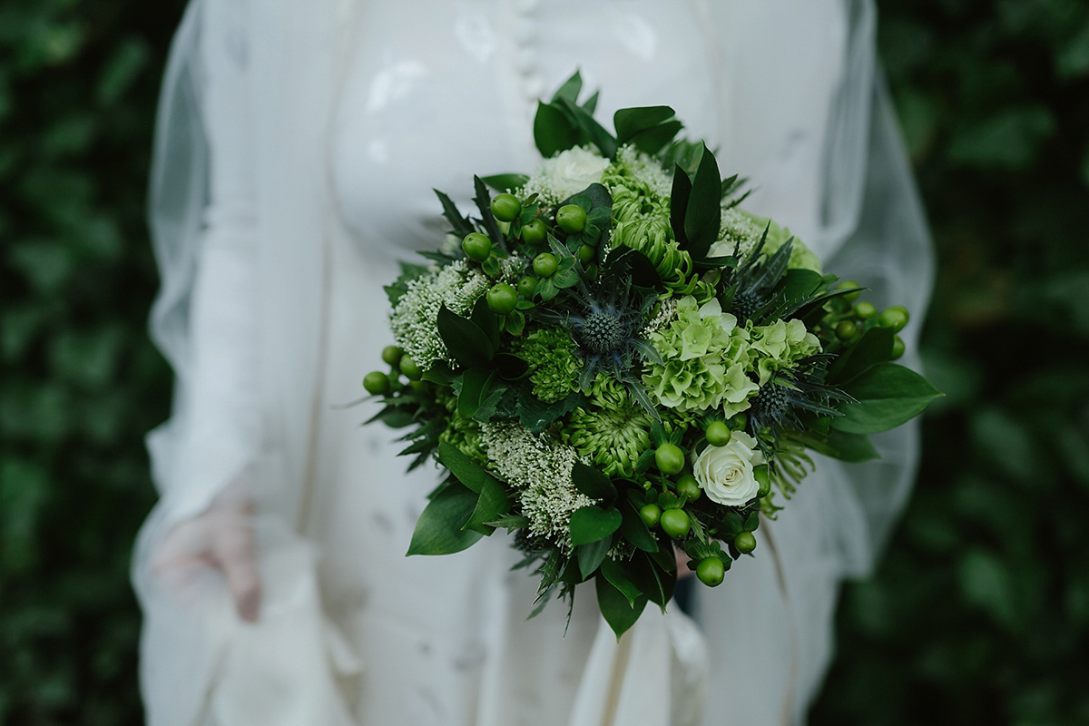 Berenice wore a 1930's vintage wedding dress for her intimate wedding held at home. The couple's ceremony involved a traditional Celtic handfasting. Photography by Rooftop Mosaic.