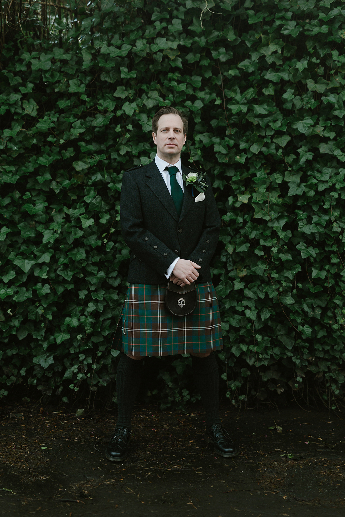 Berenice wore a 1930's vintage wedding dress for her intimate wedding held at home. The couple's ceremony involved a traditional Celtic handfasting. Photography by Rooftop Mosaic.