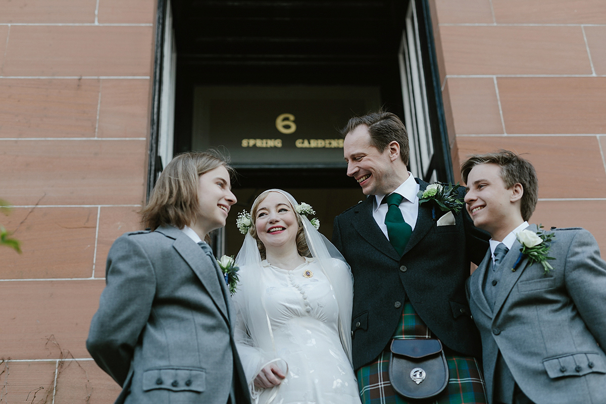 Berenice wore a 1930's vintage wedding dress for her intimate wedding held at home. The couple's ceremony involved a traditional Celtic handfasting. Photography by Rooftop Mosaic.