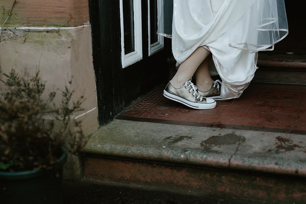 Berenice wore a 1930's vintage wedding dress for her intimate wedding held at home. The couple's ceremony involved a traditional Celtic handfasting. Photography by Rooftop Mosaic.