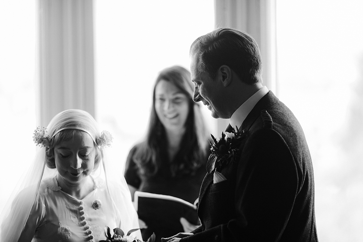 Berenice wore a 1930's vintage wedding dress for her intimate wedding held at home. The couple's ceremony involved a traditional Celtic handfasting. Photography by Rooftop Mosaic.