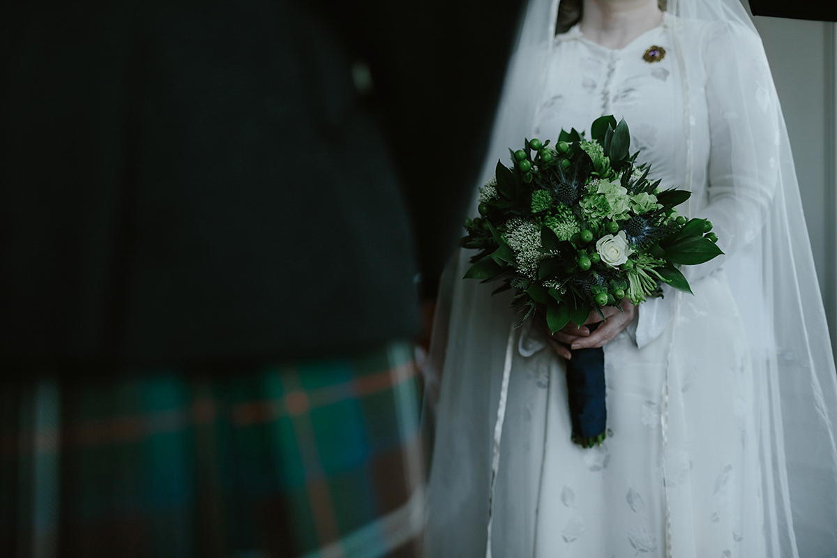 Berenice wore a 1930's vintage wedding dress for her intimate wedding held at home. The couple's ceremony involved a traditional Celtic handfasting. Photography by Rooftop Mosaic.