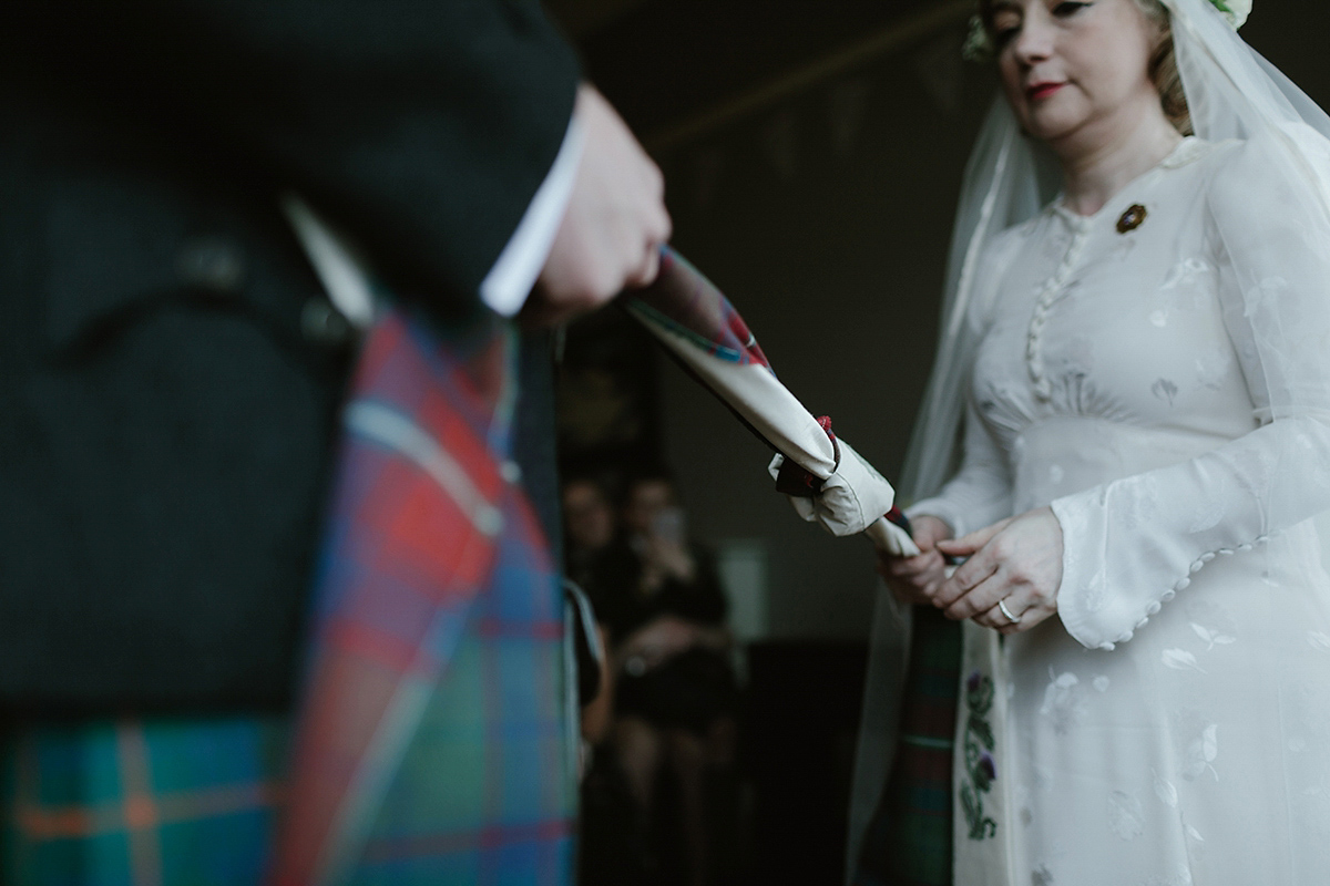 Berenice wore a 1930's vintage wedding dress for her intimate wedding held at home. The couple's ceremony involved a traditional Celtic handfasting. Photography by Rooftop Mosaic.