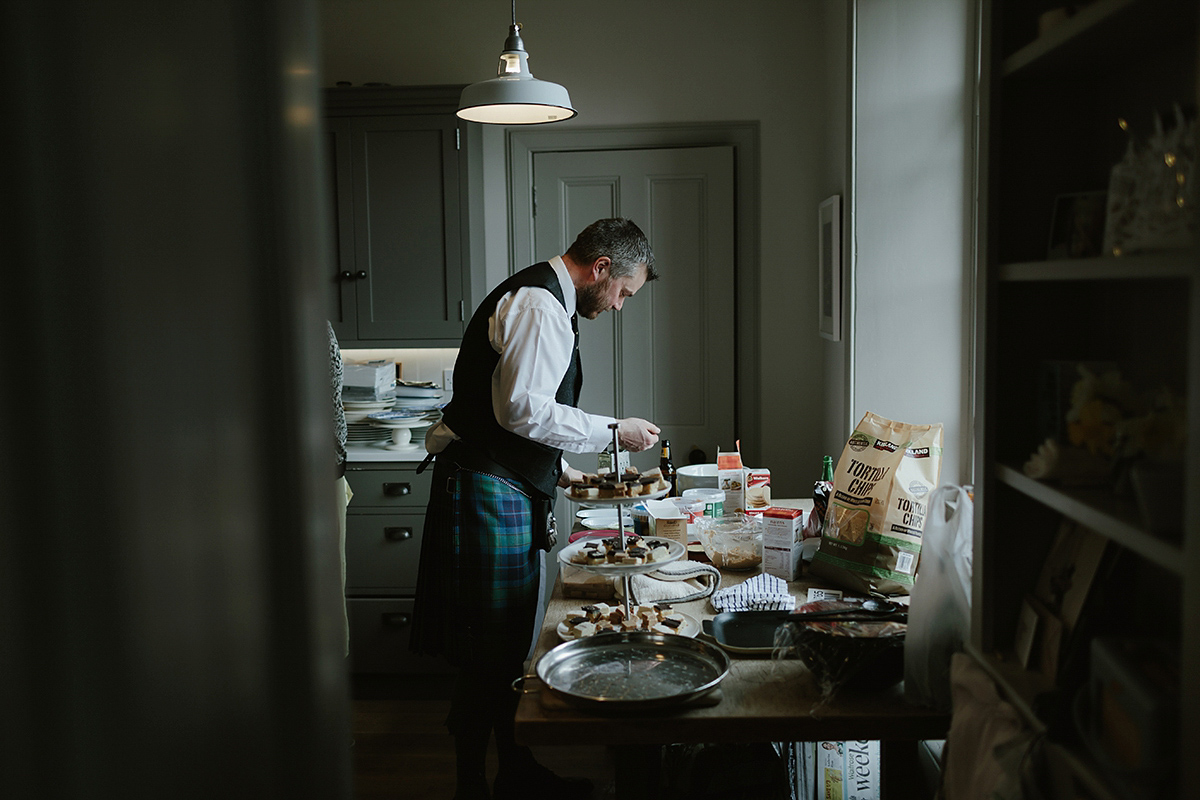 Berenice wore a 1930's vintage wedding dress for her intimate wedding held at home. The couple's ceremony involved a traditional Celtic handfasting. Photography by Rooftop Mosaic.