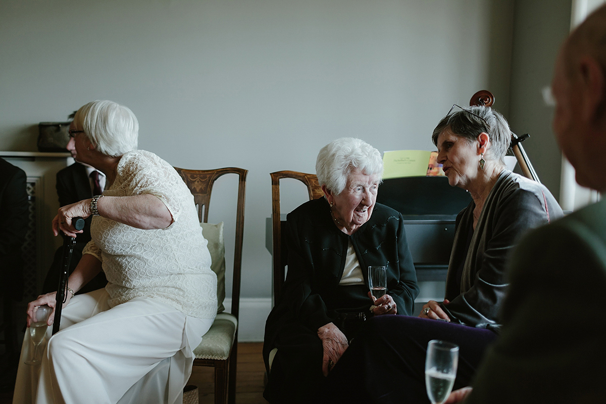 Berenice wore a 1930's vintage wedding dress for her intimate wedding held at home. The couple's ceremony involved a traditional Celtic handfasting. Photography by Rooftop Mosaic.