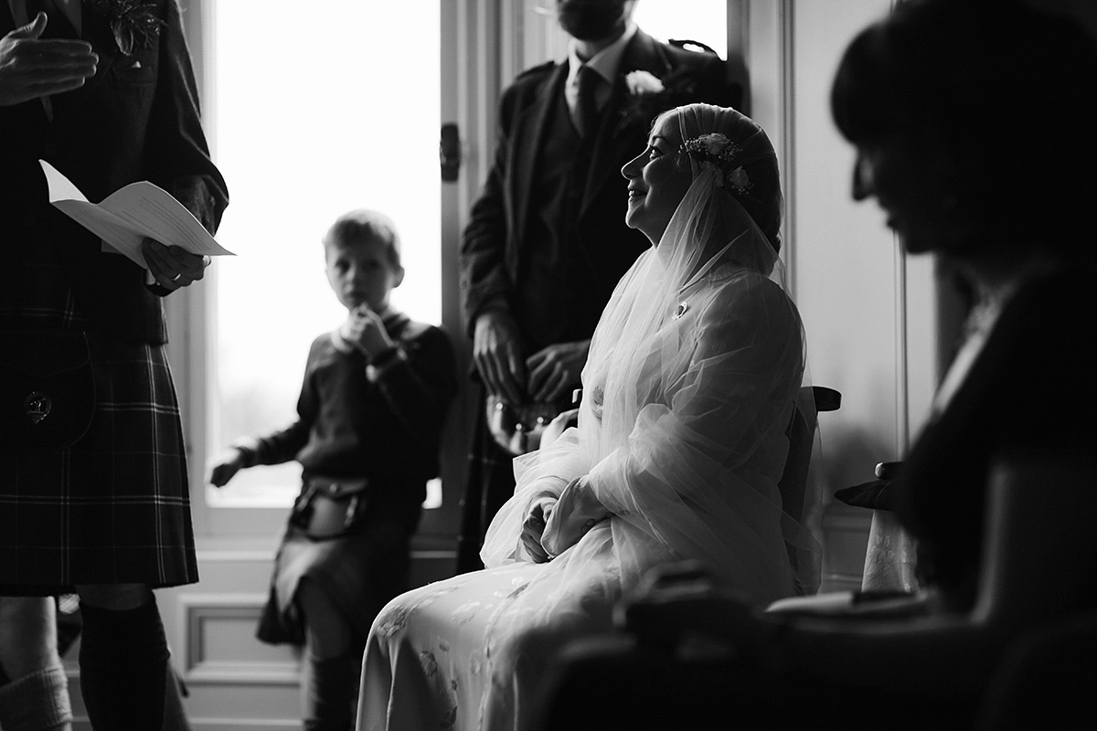 Berenice wore a 1930's vintage wedding dress for her intimate wedding held at home. The couple's ceremony involved a traditional Celtic handfasting. Photography by Rooftop Mosaic.