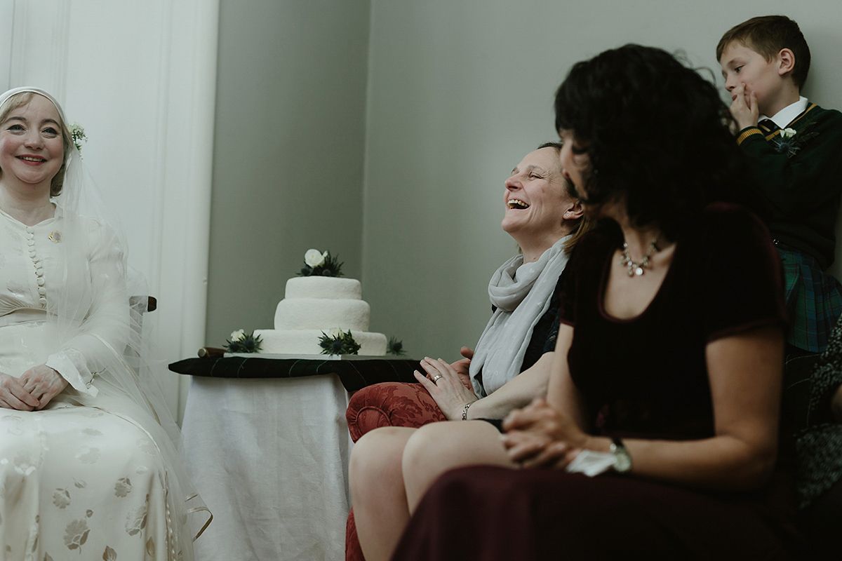 Berenice wore a 1930's vintage wedding dress for her intimate wedding held at home. The couple's ceremony involved a traditional Celtic handfasting. Photography by Rooftop Mosaic.