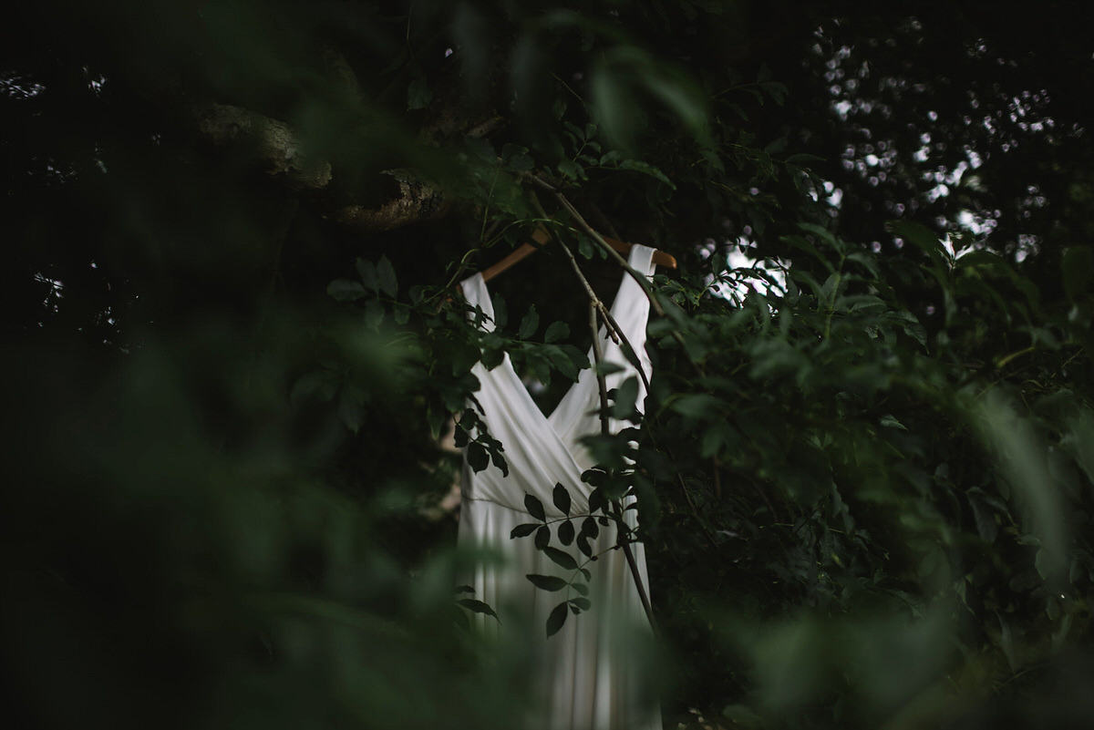 Saskia wore a Halfpenny London gown with feathered sleeves for her nature inspired wedding in Scotland. Photography by Lisa Devine.