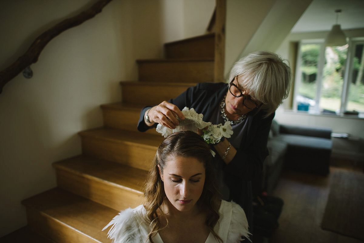 Saskia wore a Halfpenny London gown with feathered sleeves for her nature inspired wedding in Scotland. Photography by Lisa Devine.