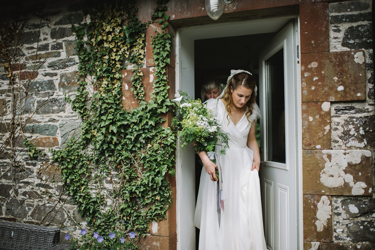 Saskia wore a Halfpenny London gown with feathered sleeves for her nature inspired wedding in Scotland. Photography by Lisa Devine.