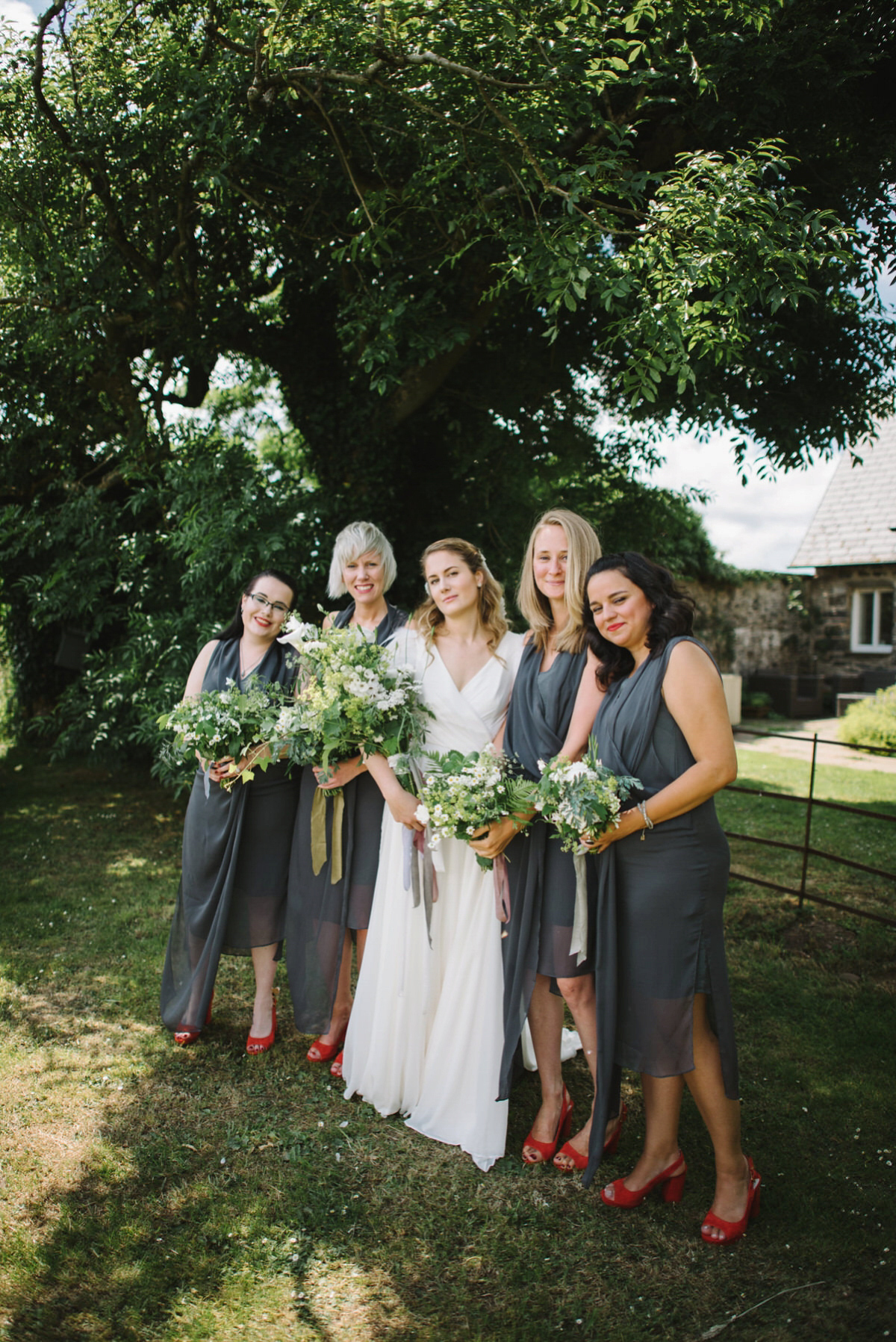 Saskia wore a Halfpenny London gown with feathered sleeves for her nature inspired wedding in Scotland. Photography by Lisa Devine.