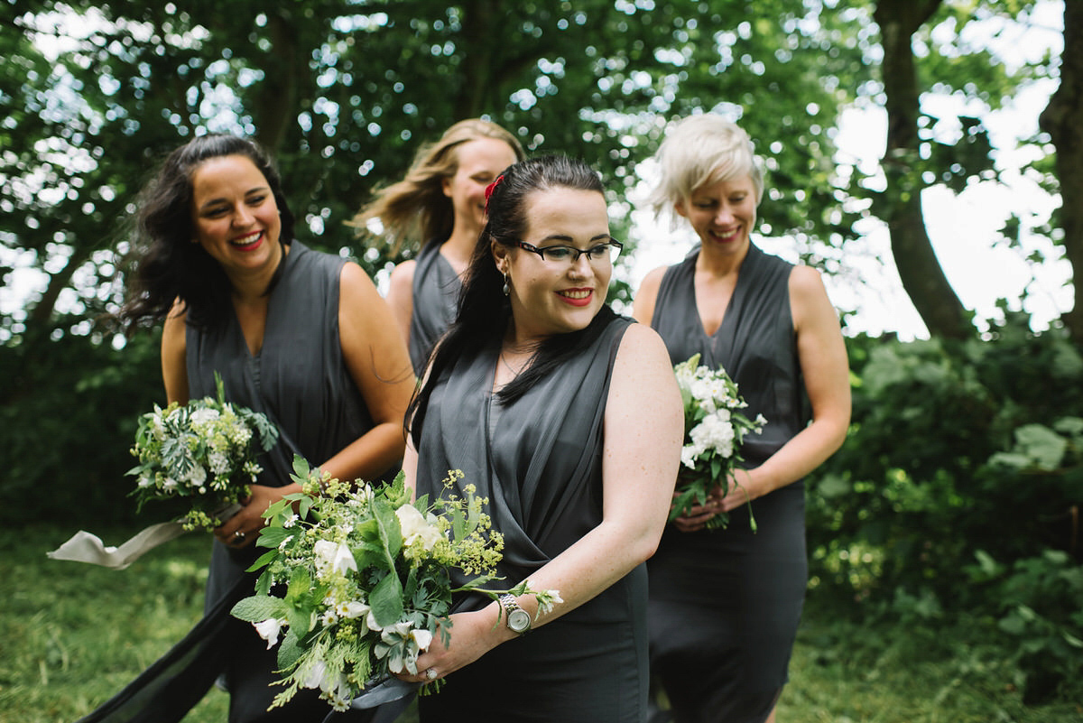 Saskia wore a Halfpenny London gown with feathered sleeves for her nature inspired wedding in Scotland. Photography by Lisa Devine.