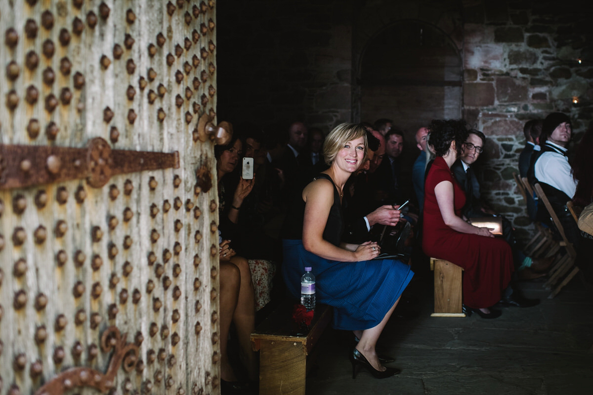 Saskia wore a Halfpenny London gown with feathered sleeves for her nature inspired wedding in Scotland. Photography by Lisa Devine.