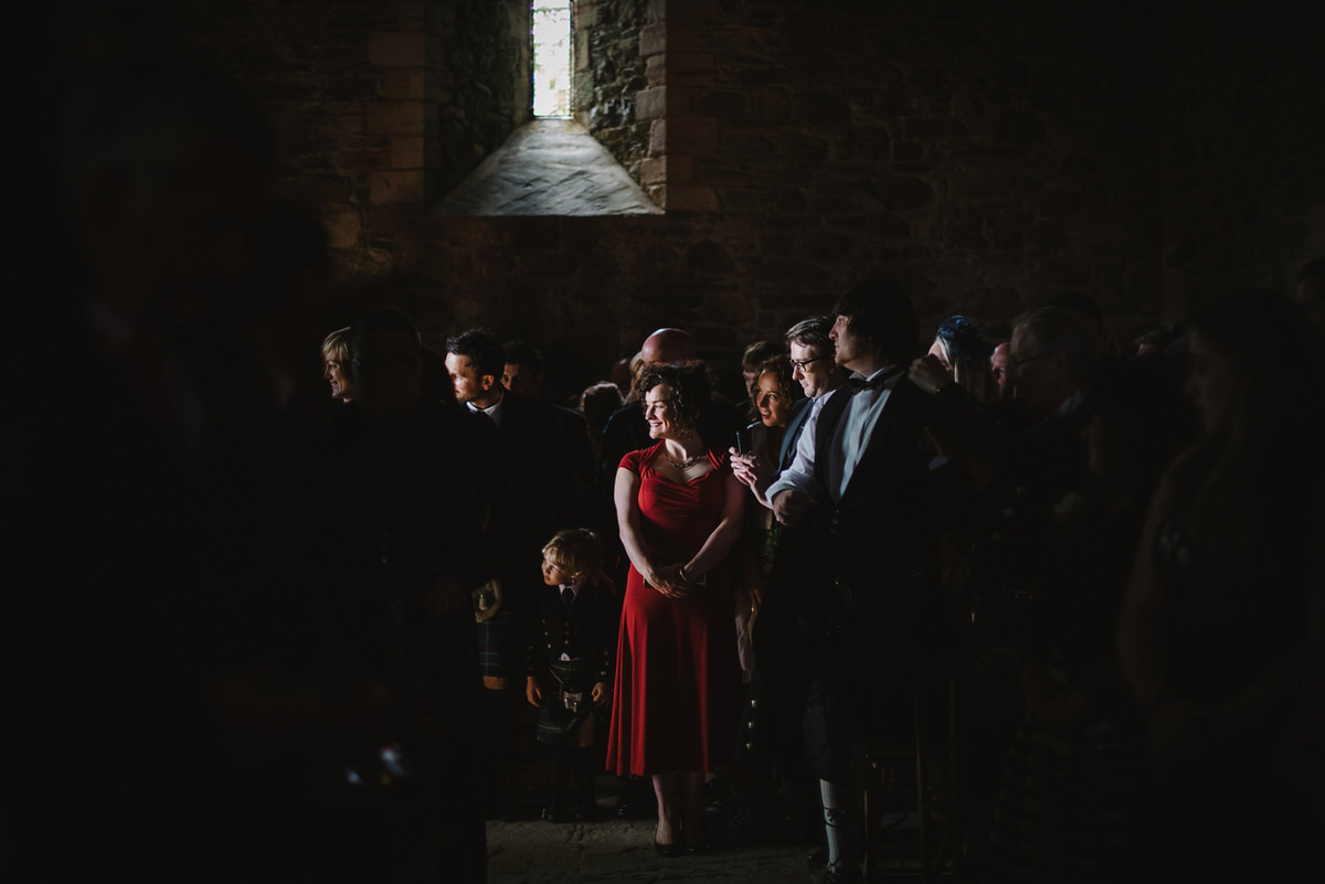 Saskia wore a Halfpenny London gown with feathered sleeves for her nature inspired wedding in Scotland. Photography by Lisa Devine.