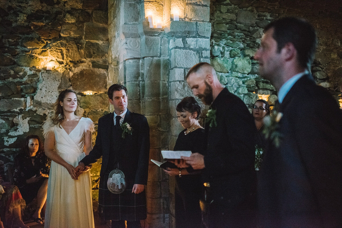 Saskia wore a Halfpenny London gown with feathered sleeves for her nature inspired wedding in Scotland. Photography by Lisa Devine.