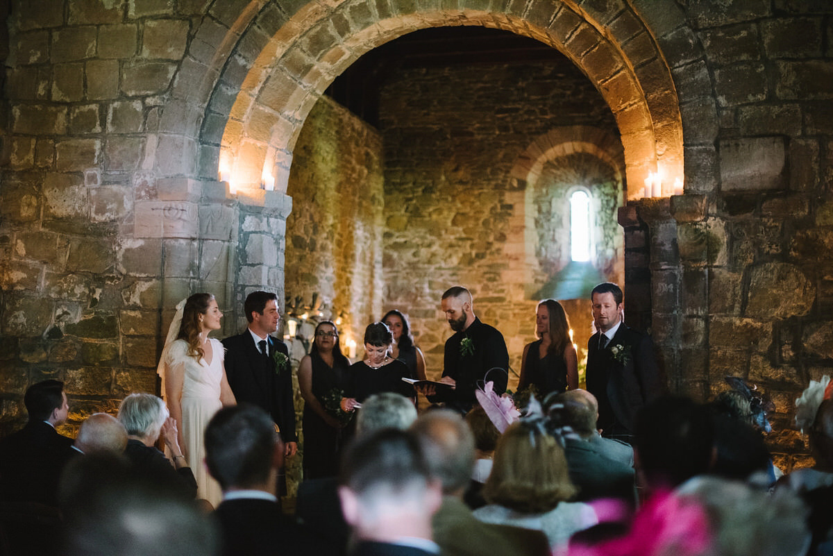 Saskia wore a Halfpenny London gown with feathered sleeves for her nature inspired wedding in Scotland. Photography by Lisa Devine.