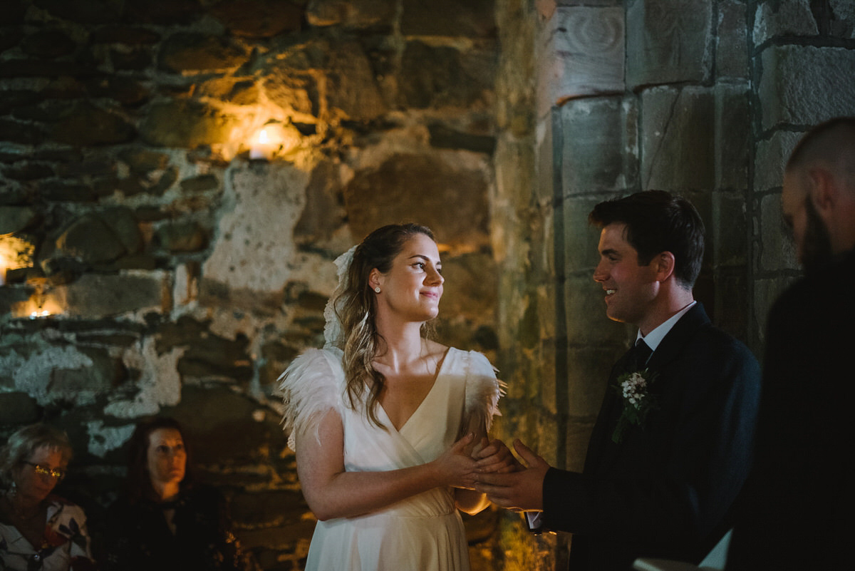 Saskia wore a Halfpenny London gown with feathered sleeves for her nature inspired wedding in Scotland. Photography by Lisa Devine.