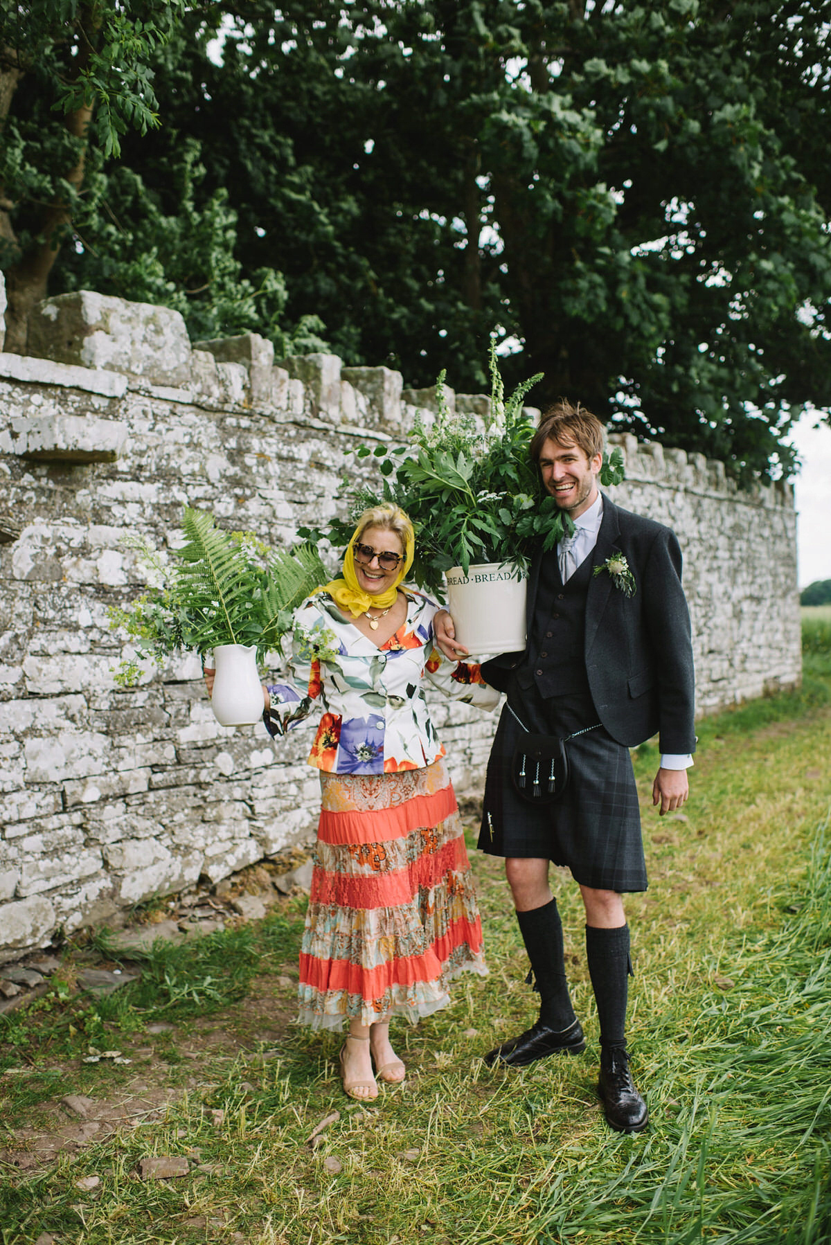 Saskia wore a Halfpenny London gown with feathered sleeves for her nature inspired wedding in Scotland. Photography by Lisa Devine.