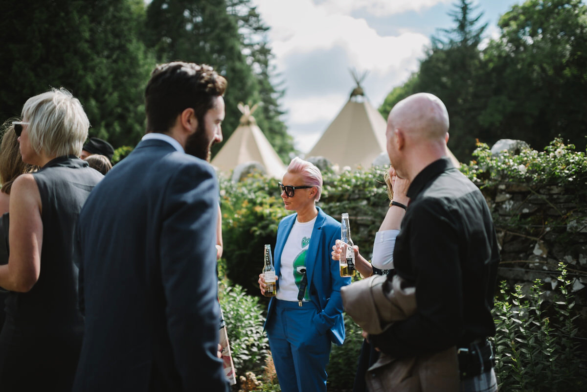 Saskia wore a Halfpenny London gown with feathered sleeves for her nature inspired wedding in Scotland. Photography by Lisa Devine.