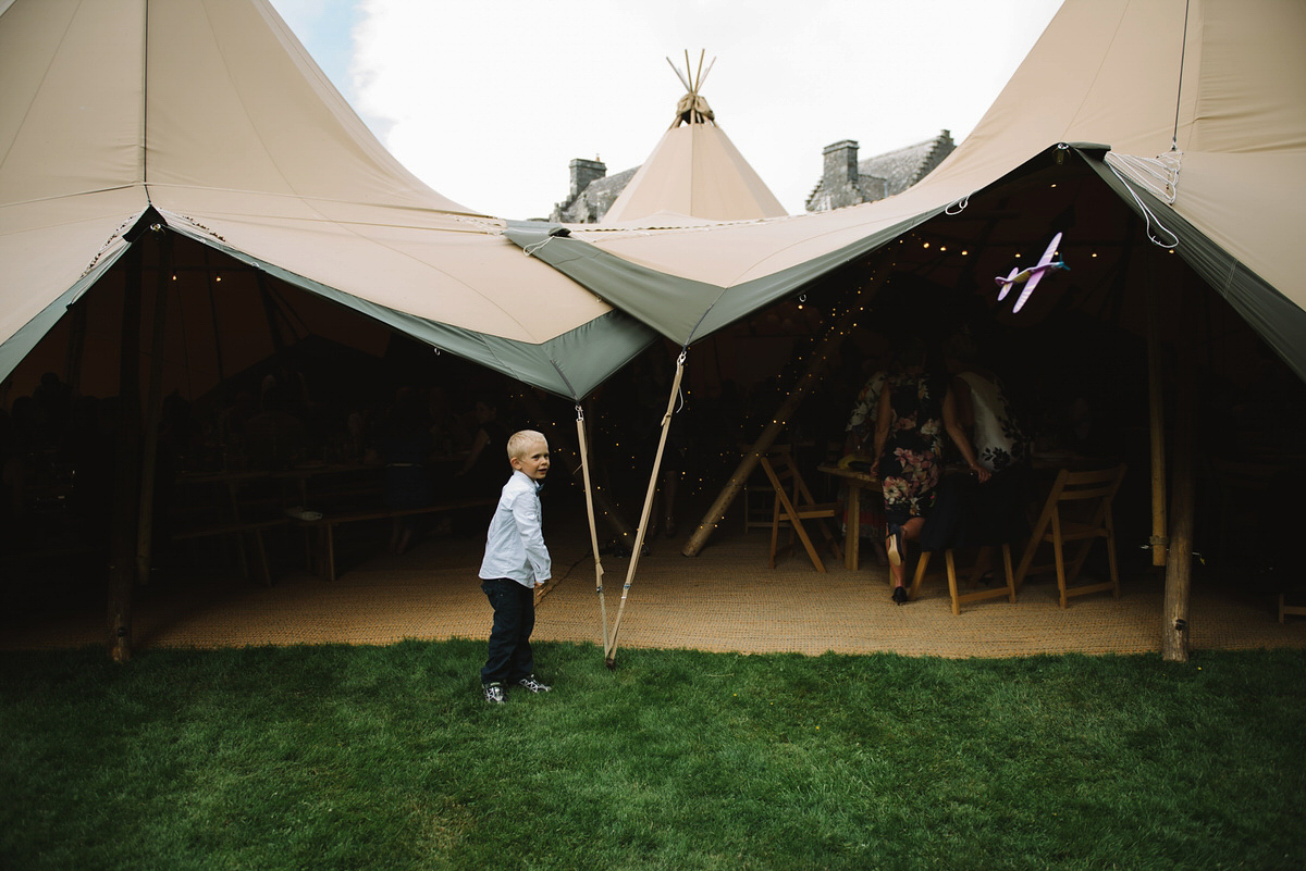 Saskia wore a Halfpenny London gown with feathered sleeves for her nature inspired wedding in Scotland. Photography by Lisa Devine.