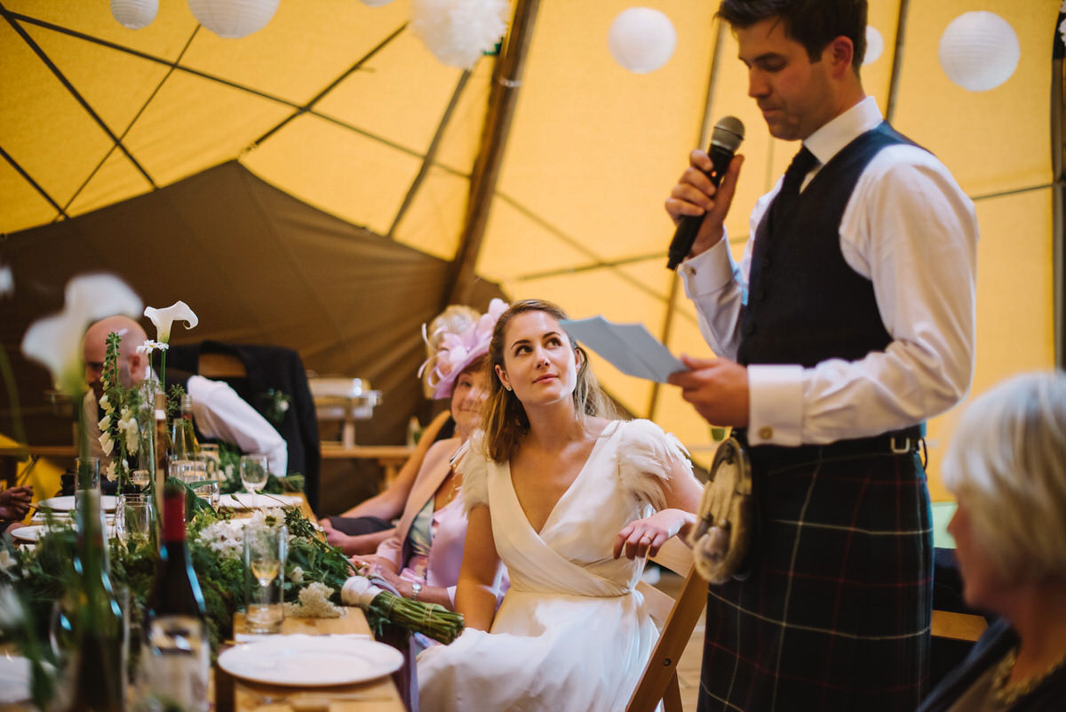 Saskia wore a Halfpenny London gown with feathered sleeves for her nature inspired wedding in Scotland. Photography by Lisa Devine.