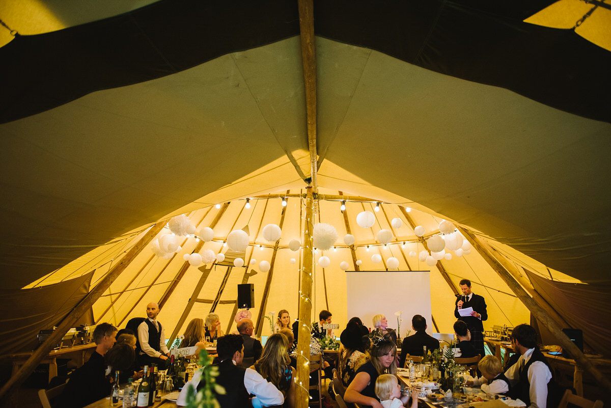 Saskia wore a Halfpenny London gown with feathered sleeves for her nature inspired wedding in Scotland. Photography by Lisa Devine.