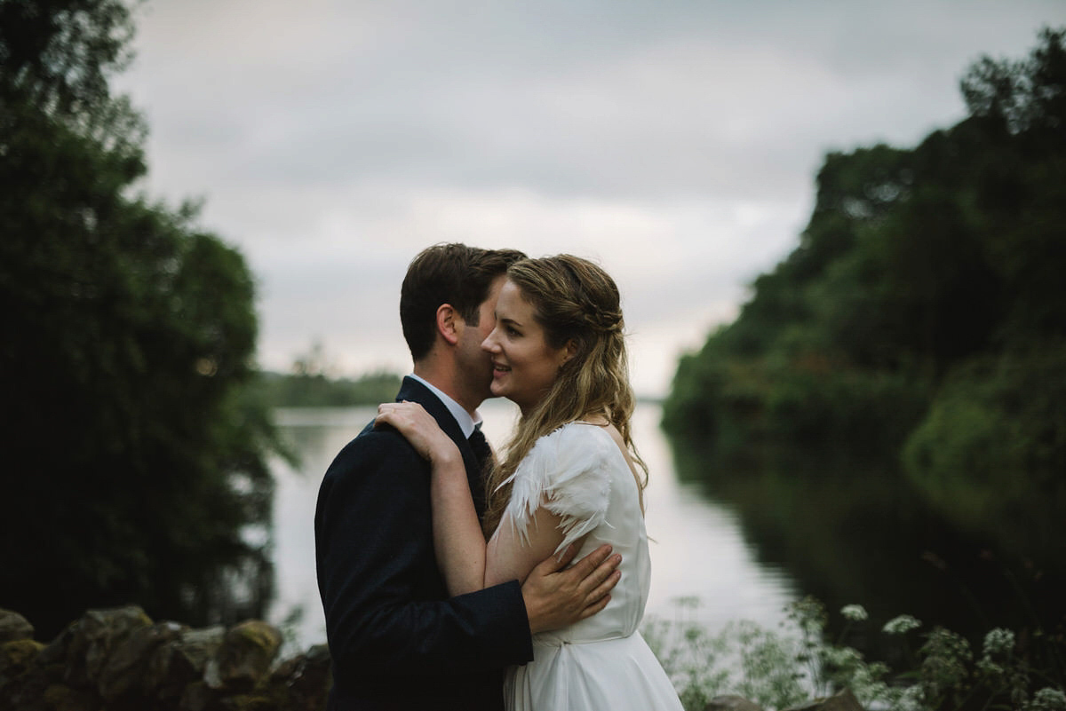 Saskia wore a Halfpenny London gown with feathered sleeves for her nature inspired wedding in Scotland. Photography by Lisa Devine.