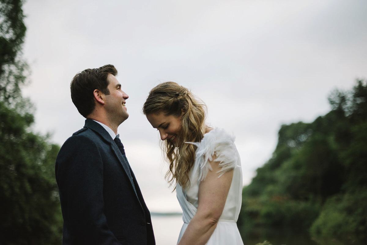 Saskia wore a Halfpenny London gown with feathered sleeves for her nature inspired wedding in Scotland. Photography by Lisa Devine.