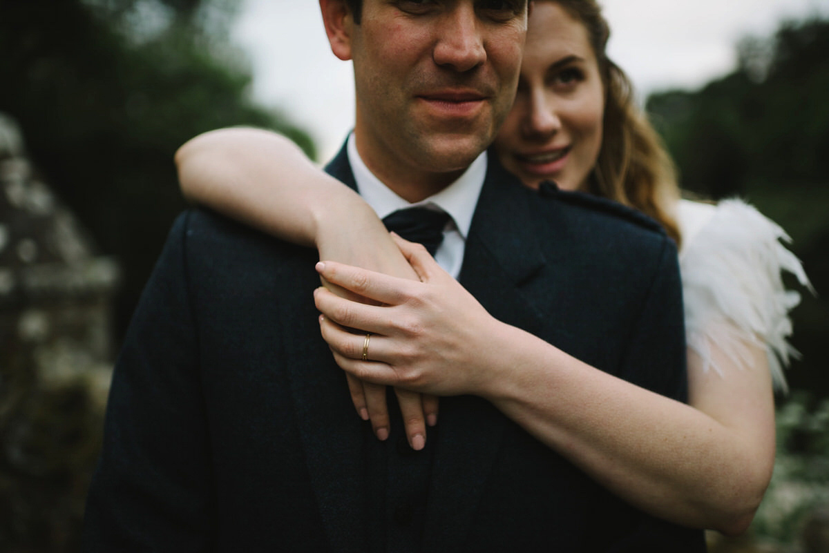 Saskia wore a Halfpenny London gown with feathered sleeves for her nature inspired wedding in Scotland. Photography by Lisa Devine.