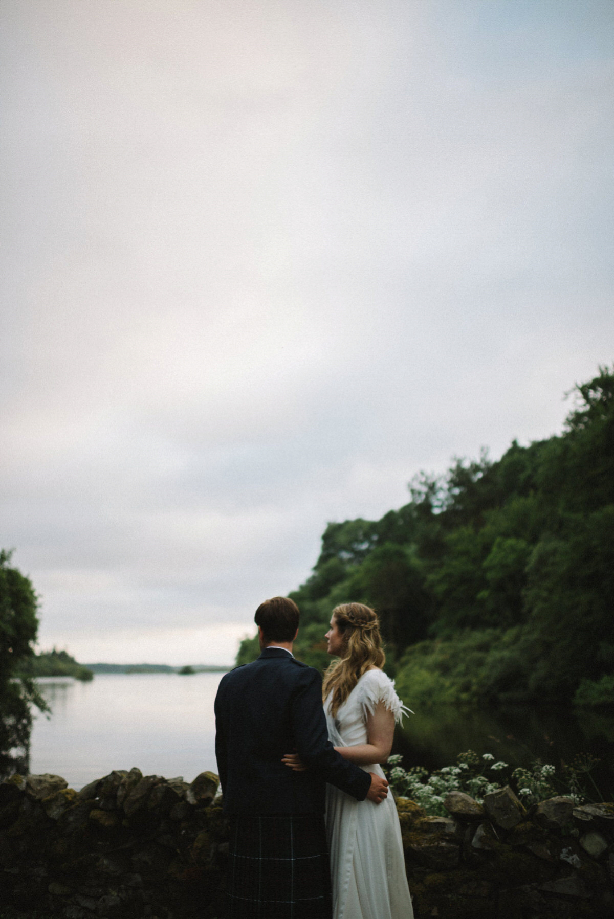 Saskia wore a Halfpenny London gown with feathered sleeves for her nature inspired wedding in Scotland. Photography by Lisa Devine.