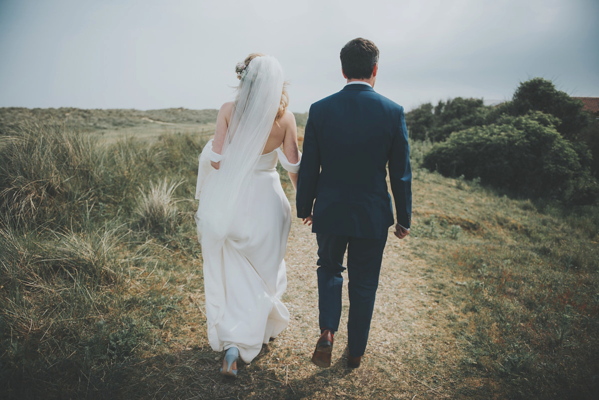 Anya wore a Sabina Motasem gown and floral crown for her vintage seaside inspired wedding. Photography by Eliza Claire.