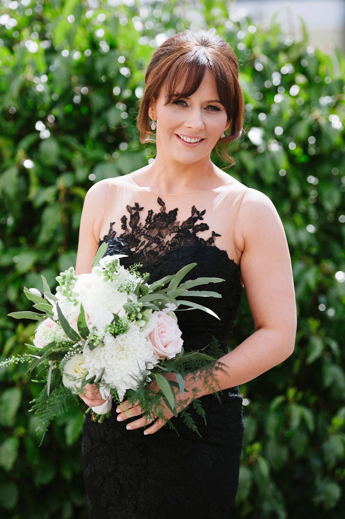 The bride wore a Peter Langner gown and the bridesmaids wore black Pronovias cocktail dresses. Photography by Saray Fyffe.