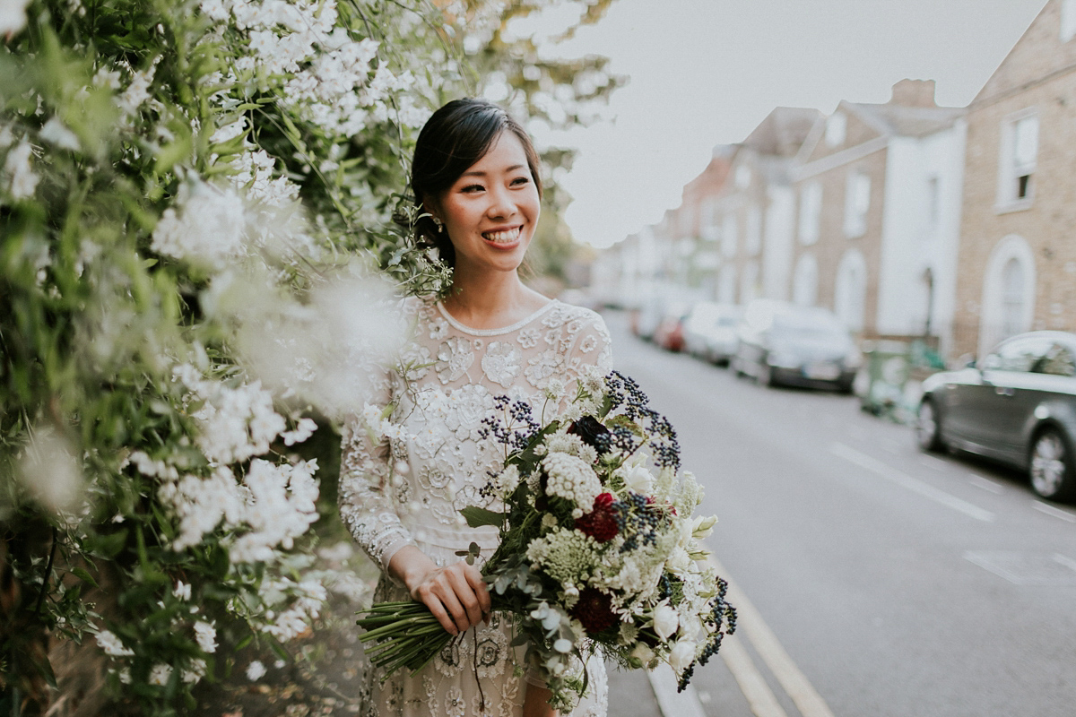Bride Su wore a Needle & Thread wedding dress for her modern and elegant London wedding. She and her husband Nik met through online dating agency, Guardian Soulmates.
