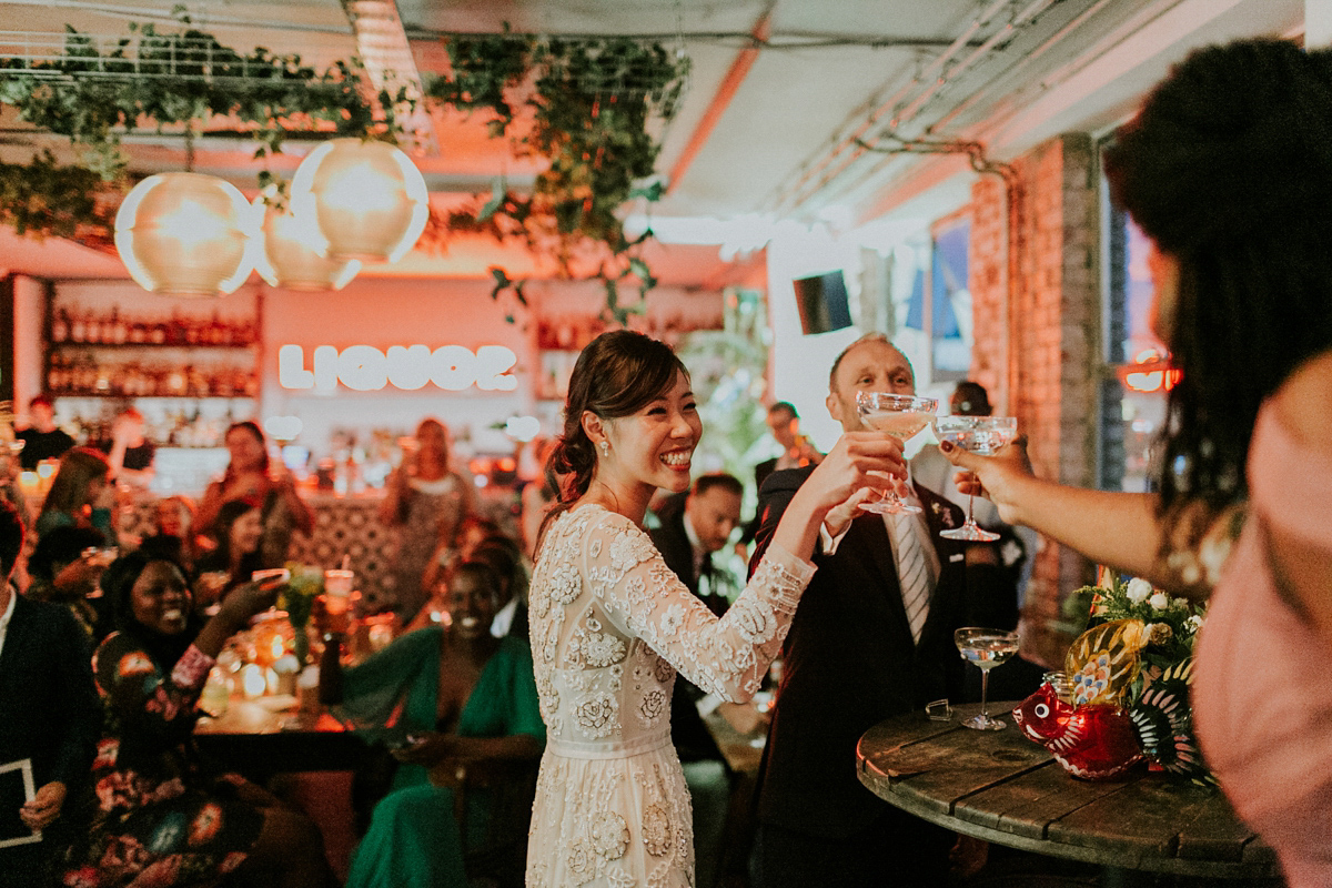 Bride Su wore a Needle & Thread wedding dress for her modern and elegant London wedding. She and her husband Nik met through online dating agency, Guardian Soulmates.