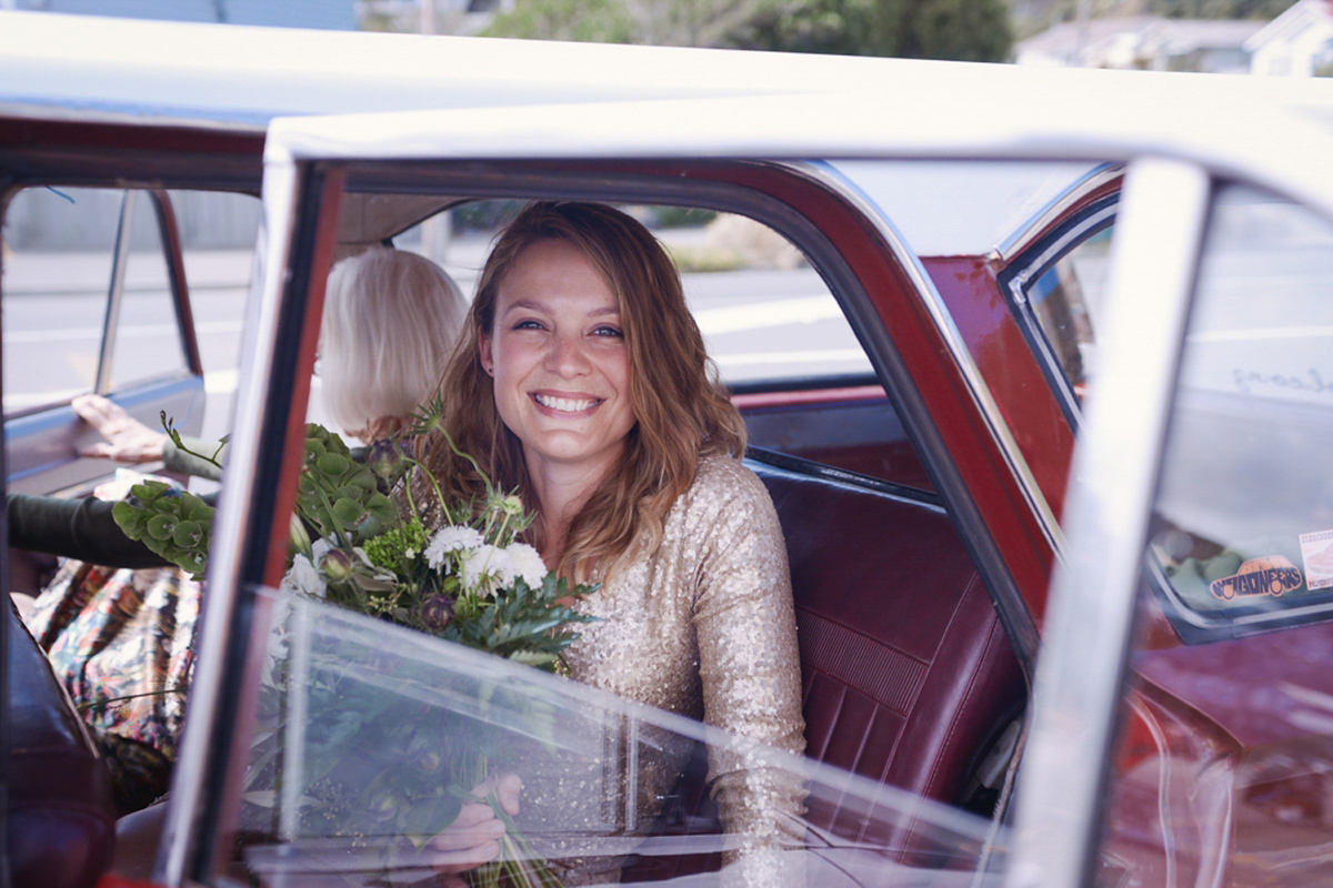 Amelia wore a gold sequin wedding dress for her relaxed, homespun and handmade wedding by the seaside in New Zealand. Photography by Sarah Burton.