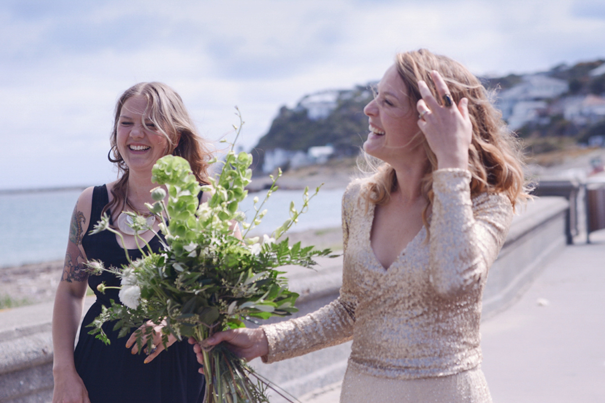 Amelia wore a gold sequin wedding dress for her relaxed, homespun and handmade wedding by the seaside in New Zealand. Photography by Sarah Burton.