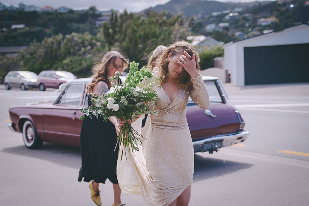 Amelia wore a gold sequin wedding dress for her relaxed, homespun and handmade wedding by the seaside in New Zealand. Photography by Sarah Burton.