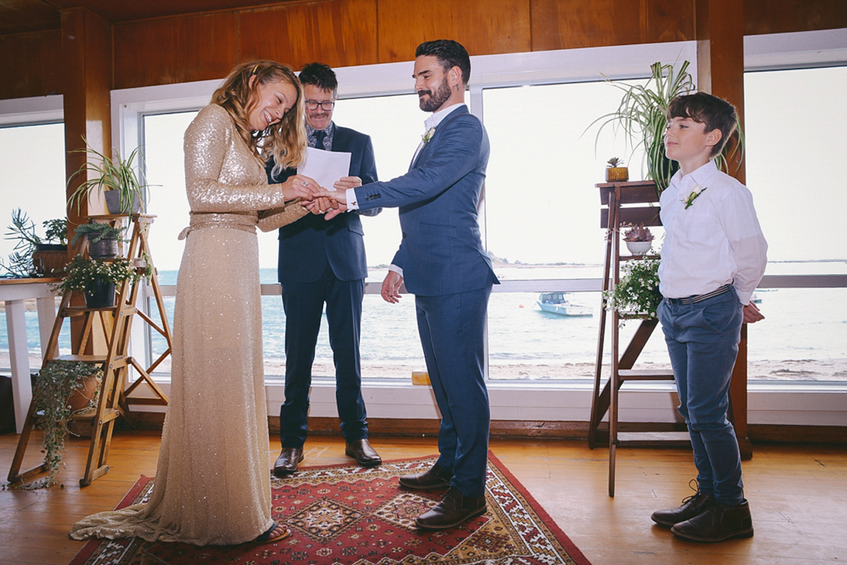 Amelia wore a gold sequin wedding dress for her relaxed, homespun and handmade wedding by the seaside in New Zealand. Photography by Sarah Burton.