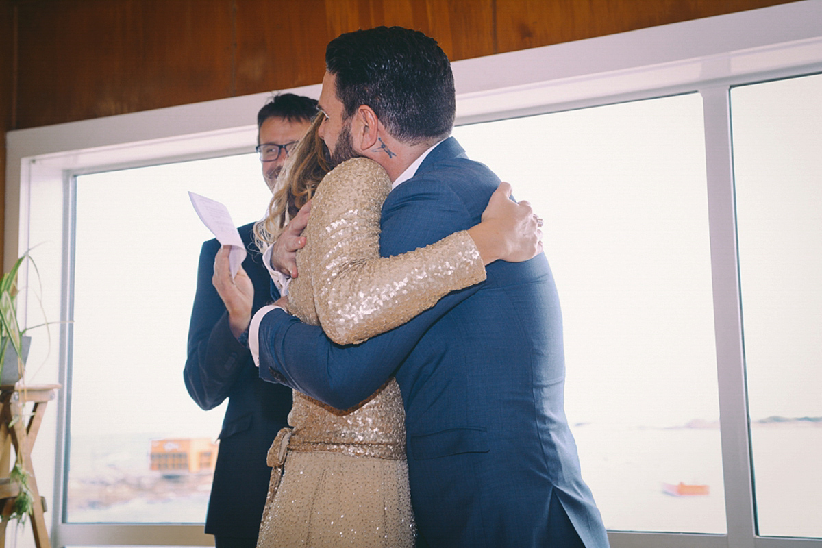 Amelia wore a gold sequin wedding dress for her relaxed, homespun and handmade wedding by the seaside in New Zealand. Photography by Sarah Burton.