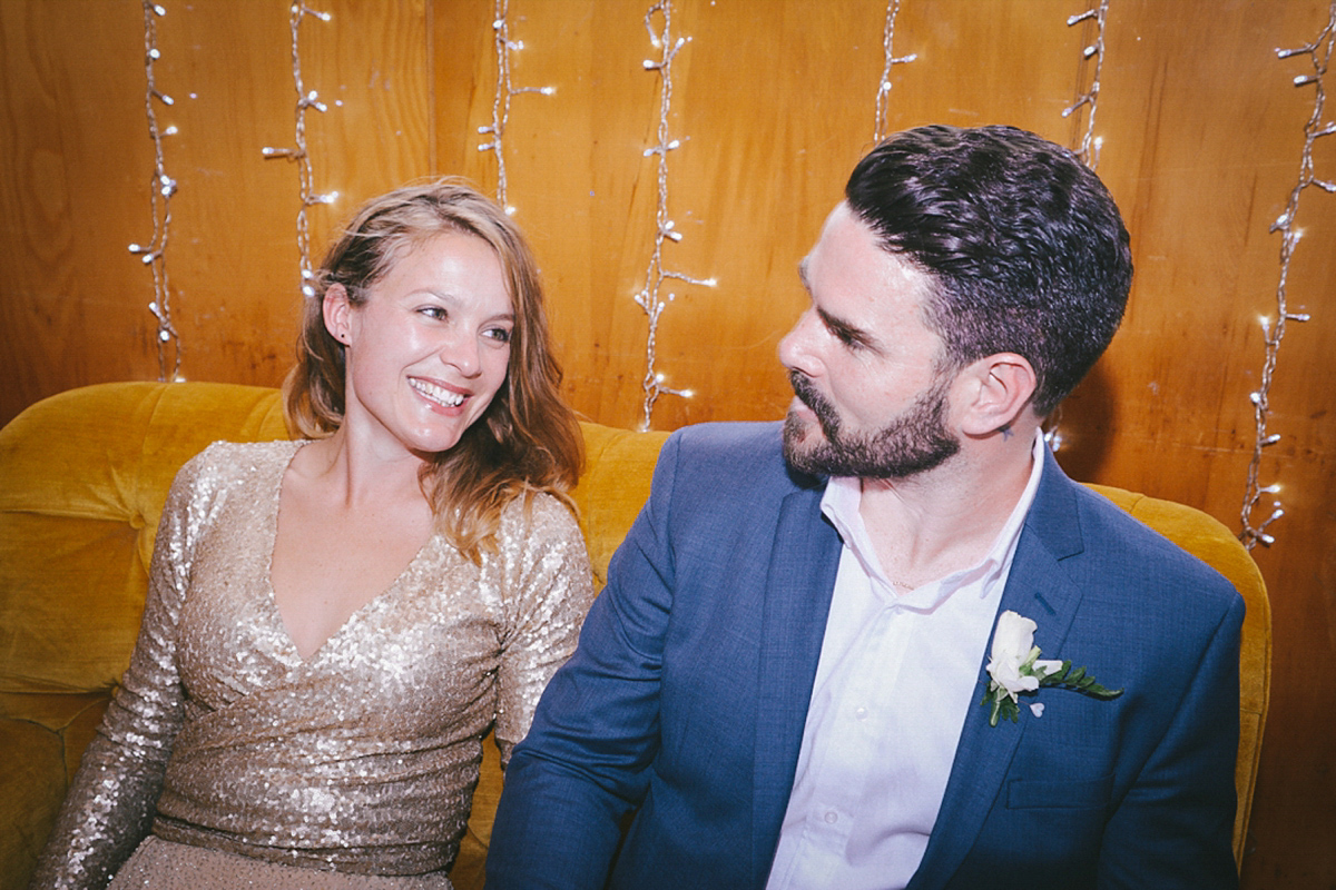 Amelia wore a gold sequin wedding dress for her relaxed, homespun and handmade wedding by the seaside in New Zealand. Photography by Sarah Burton.