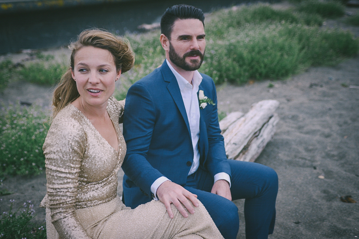 Amelia wore a gold sequin wedding dress for her relaxed, homespun and handmade wedding by the seaside in New Zealand. Photography by Sarah Burton.