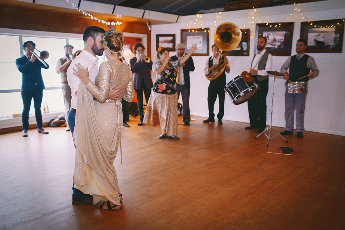 Amelia wore a gold sequin wedding dress for her relaxed, homespun and handmade wedding by the seaside in New Zealand. Photography by Sarah Burton.