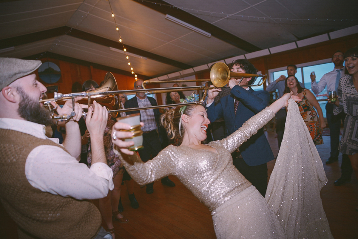 Amelia wore a gold sequin wedding dress for her relaxed, homespun and handmade wedding by the seaside in New Zealand. Photography by Sarah Burton.