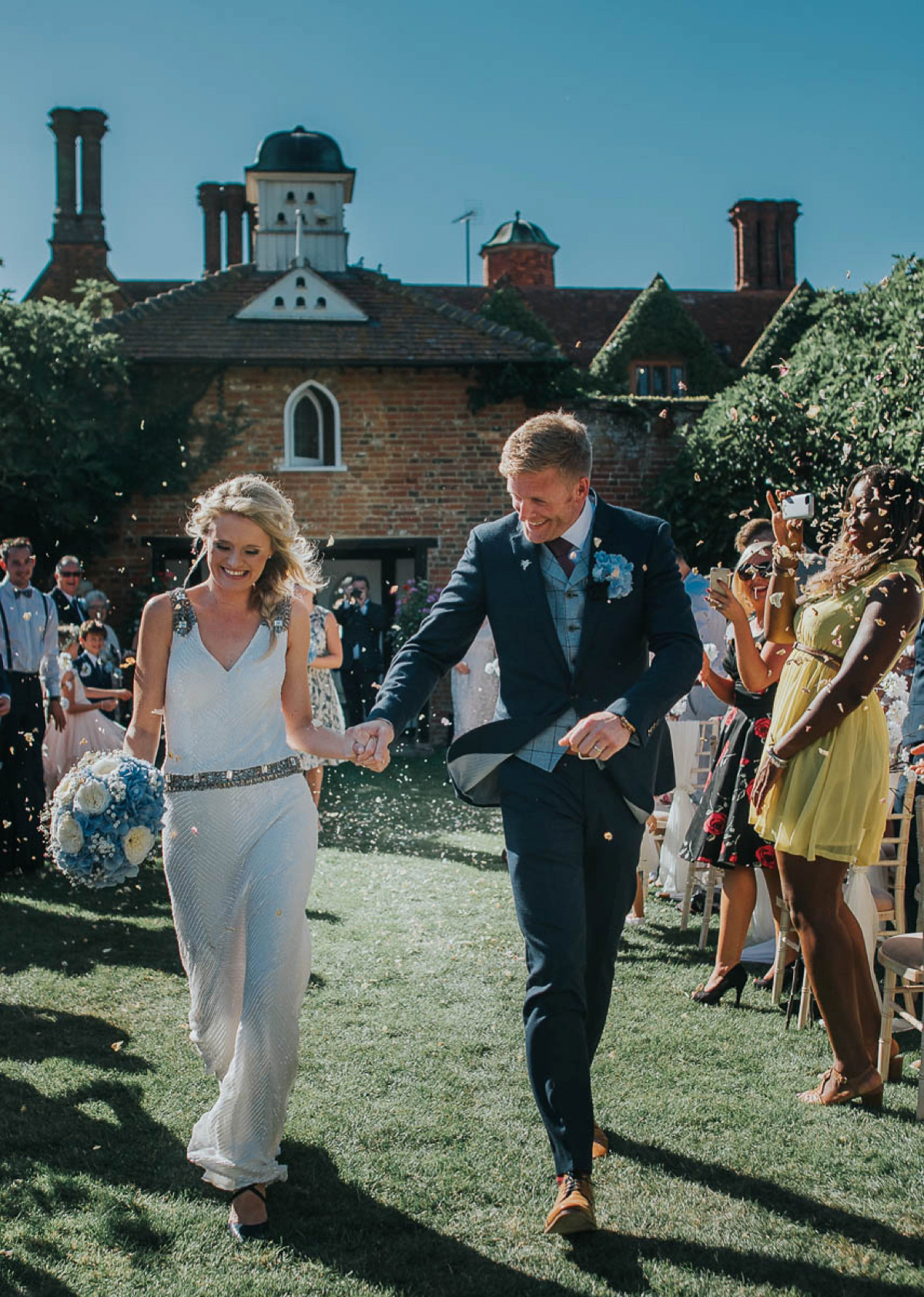 Bride Faye wears an 1930's inspired drop waist glamorous dress by Eliza jane Howell for her effortlessly elegant summer garden party wedding.