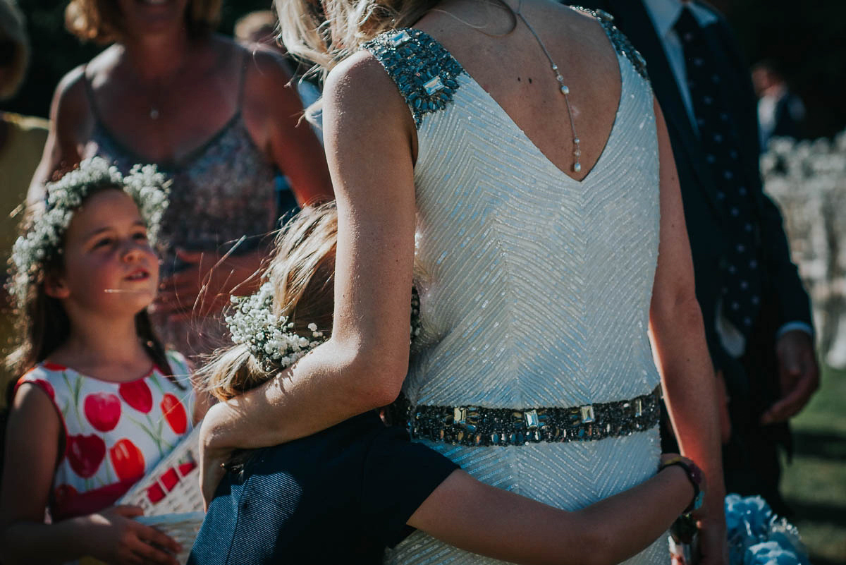 Bride Faye wears an 1930's inspired drop waist glamorous dress by Eliza jane Howell for her effortlessly elegant summer garden party wedding.