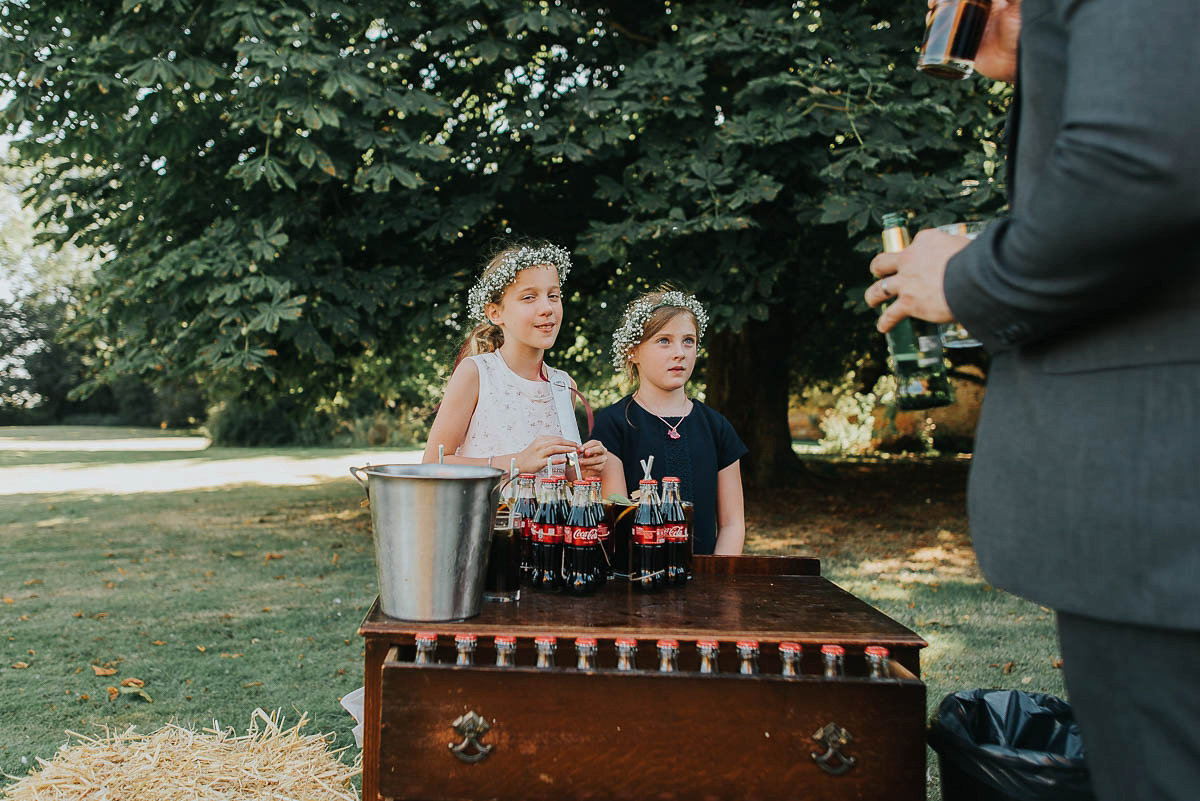 Bride Faye wears an 1930's inspired drop waist glamorous dress by Eliza jane Howell for her effortlessly elegant summer garden party wedding.