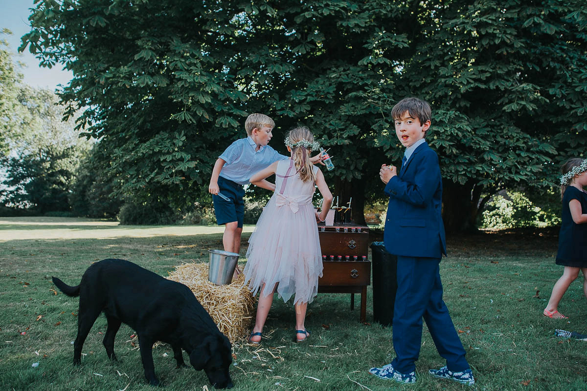 Bride Faye wears an 1930's inspired drop waist glamorous dress by Eliza jane Howell for her effortlessly elegant summer garden party wedding.