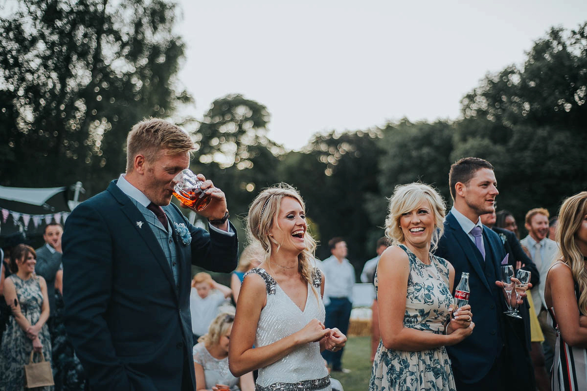 Bride Faye wears an 1930's inspired drop waist glamorous dress by Eliza jane Howell for her effortlessly elegant summer garden party wedding.