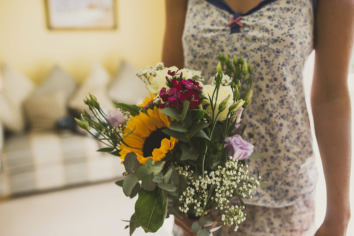 Ashleigh wore an elegant Charlie Brear gown for her sunshine and sunflower filled wedding. A Mariachi band entertained guests at the reception. Bridesmaids wore ASOS. Photography by The Springles.